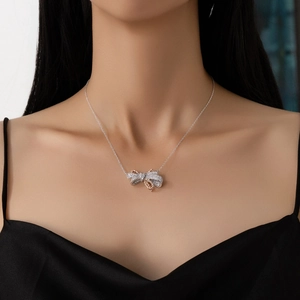 S925 sterling silver bow necklace with two-tone plating and cubic zirconia on model