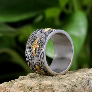 Macro detail of vintage eagle ring with gold relief on rustic stone background