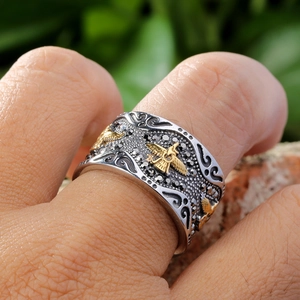 Vintage eagle stainless steel ring featuring black stones and golden relief details