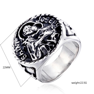 Macro view of vintage Saint Joseph steel ring showing relief carving and size details