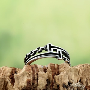Retro punk titanium steel ring with hollow chain design and T-shaped motif on tree bark