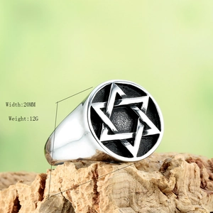 Vintage stainless steel hexagram ring with 20mm width on natural wood background
