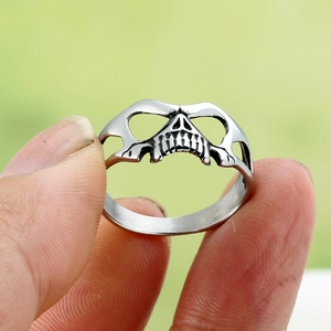 Close-up of retro hollow skull ring in matte silver finish with punk style details
