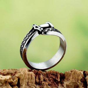 Vintage punk dagger ring for men in silver finish with scale texture on natural wood base