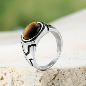 Vintage stainless steel ring for men with oval tiger eye stone on a textured stone