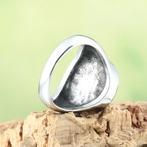 Mens vintage stainless steel hexagram ring with textured inner band on wood block