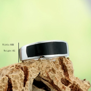 Vintage style 8mm stainless steel ring with black enamel inlay on natural bark background