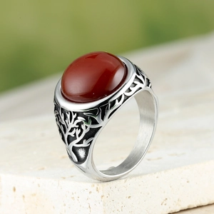 Macro detail of retro silver ring with large red agate stone and tree engraving