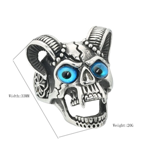 Gothic skull ring in vintage silver with ram horns and blue gemstone eyes, 33mm width