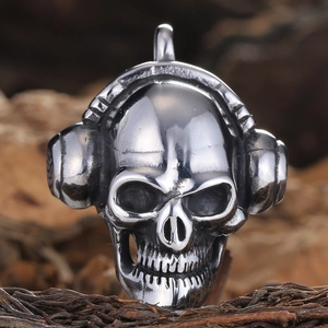 Macro shot of a punk skull pendant wearing headphones on a textured bark background