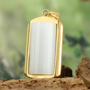 Detailed view of a gold rectangular pendant with white vertical striped stone on wood