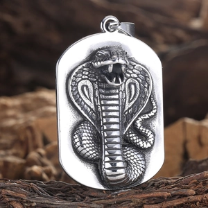 Vintage stainless steel dog tag pendant featuring high-relief cobra snake engraving