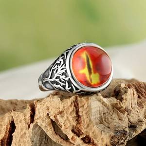 Vintage male ring with oval orange gemstone and wood branch texture on tree bark