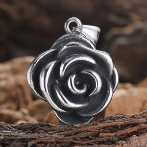 Macro detail of a vintage stainless steel rose pendant with realistic layered petals