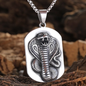 Macro shot of stainless steel cobra pendant with intricate scales and square pearl chain