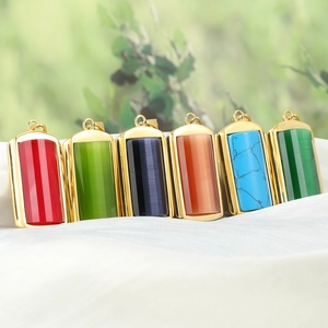 Detail of six colorful rectangular titanium steel pendants with gold trim on white silk