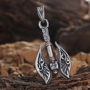 Detailed view of a Viking battle axe pendant with Nordic carvings on rustic bark