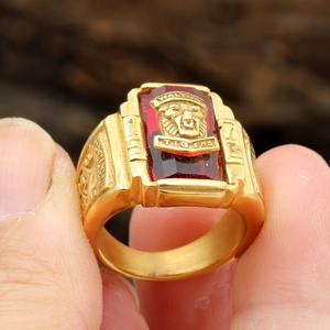 Macro shot of 1973 Walton Tigers gold signet ring with a faceted red gemstone