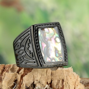 Macro view of vintage square black ring featuring iridescent abalone shell inlay