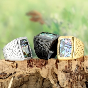 Retro square signet rings with abalone shell inlay and totem relief on wood background