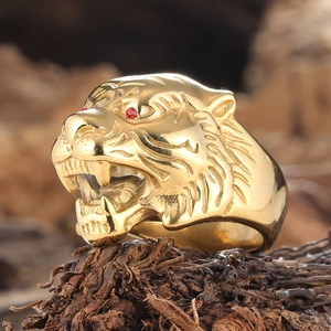 Macro view of golden tiger head ring with red gem eyes and detailed fur textures