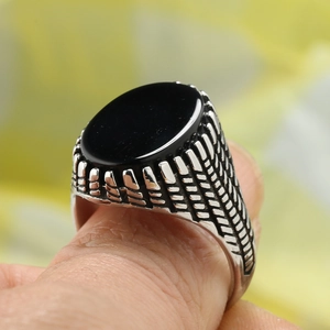 Vintage stainless steel ring for men featuring an oval black stone and braided engraving
