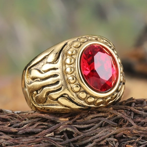 Vintage gold stainless steel ring with large oval red gemstone and flame relief details