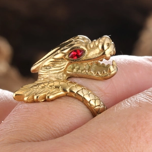 Detail of vintage dragon ring in gold finish with red crystal eye and intricate scales
