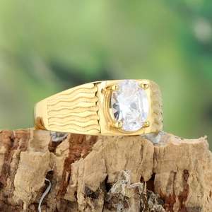 Detailed close-up of a golden titanium ring featuring an oval zircon and wavy band texture