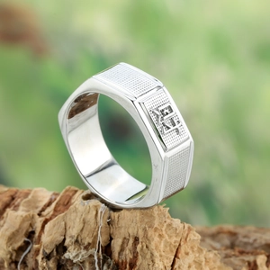 Polished silver signet ring with embossed Chinese character Cai on textured bark