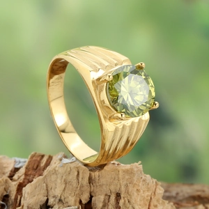 Golden wavy ripple ring with large green zircon stone in a classic four-prong setting