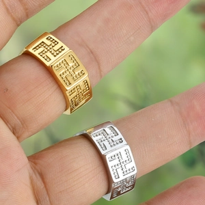 Macro shot of gold and silver titanium steel rings with engraved swastika pattern details