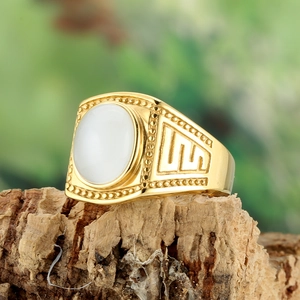 Golden titanium steel ring with white oval gemstone and geometric Greek key engraving