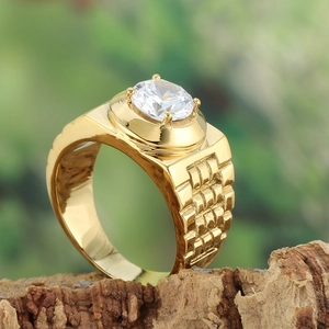 Detailed close-up of a gold ring with a large zircon stone and watchband texture