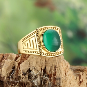 Golden titanium steel ring featuring green cat eye stone and geometric pattern details