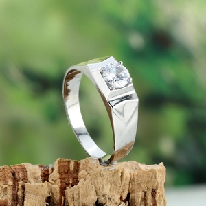 Mens silver band ring with round brilliant cut diamond solitaire on natural wood base