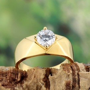 Macro shot of gold-plated men's ring with round solitaire zircon in four-prong setting