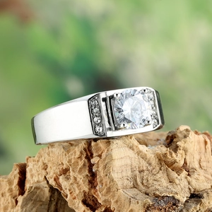 Macro shot of silver titanium ring with large round crystal on rustic tree bark