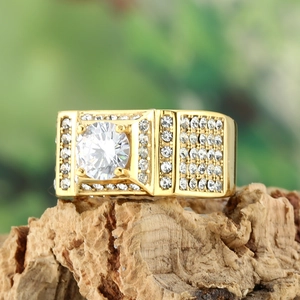 Macro view of gold square halo ring featuring round brilliant center stone and side pavé diamonds