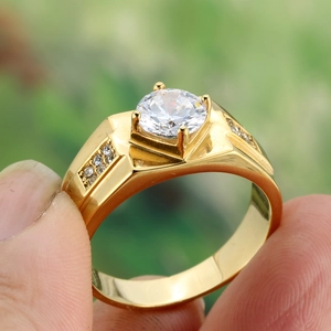 Gold plated titanium steel ring featuring a brilliant round cut zircon in 4-prong setting