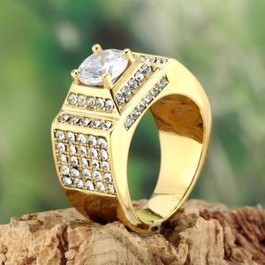 Macro shot of gold square men's ring with large center stone and pavé diamond details