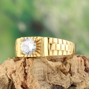 Men's gold-plated stainless steel ring with white gemstone on natural wood bark