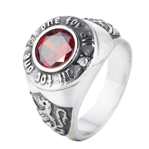 Vintage stainless steel ring with red faceted gemstone and lion crest engraving