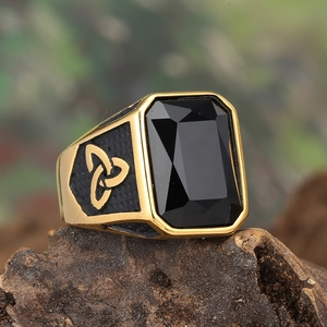 Macro view of gold Viking ring with rectangular black gemstone and Celtic knots