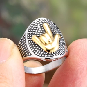 Retro punk titanium steel ring with gold gesture relief on a textured triangle face