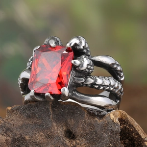 Macro view of vintage claw ring with rectangle ruby stone on rustic wood background