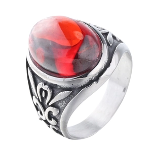 Vintage stainless steel ring featuring a large red oval stone and carved leaf patterns