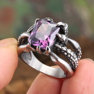 Macro view of vintage punk ring with purple gemstone and claw setting detail