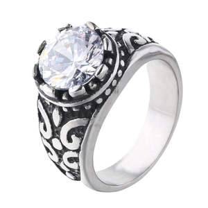 Detailed view of large round clear gemstone on vintage engraved silver band