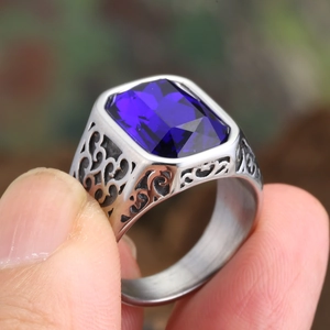 Macro detail of men's vintage ring featuring a blue rectangular stone and silver scrollwork